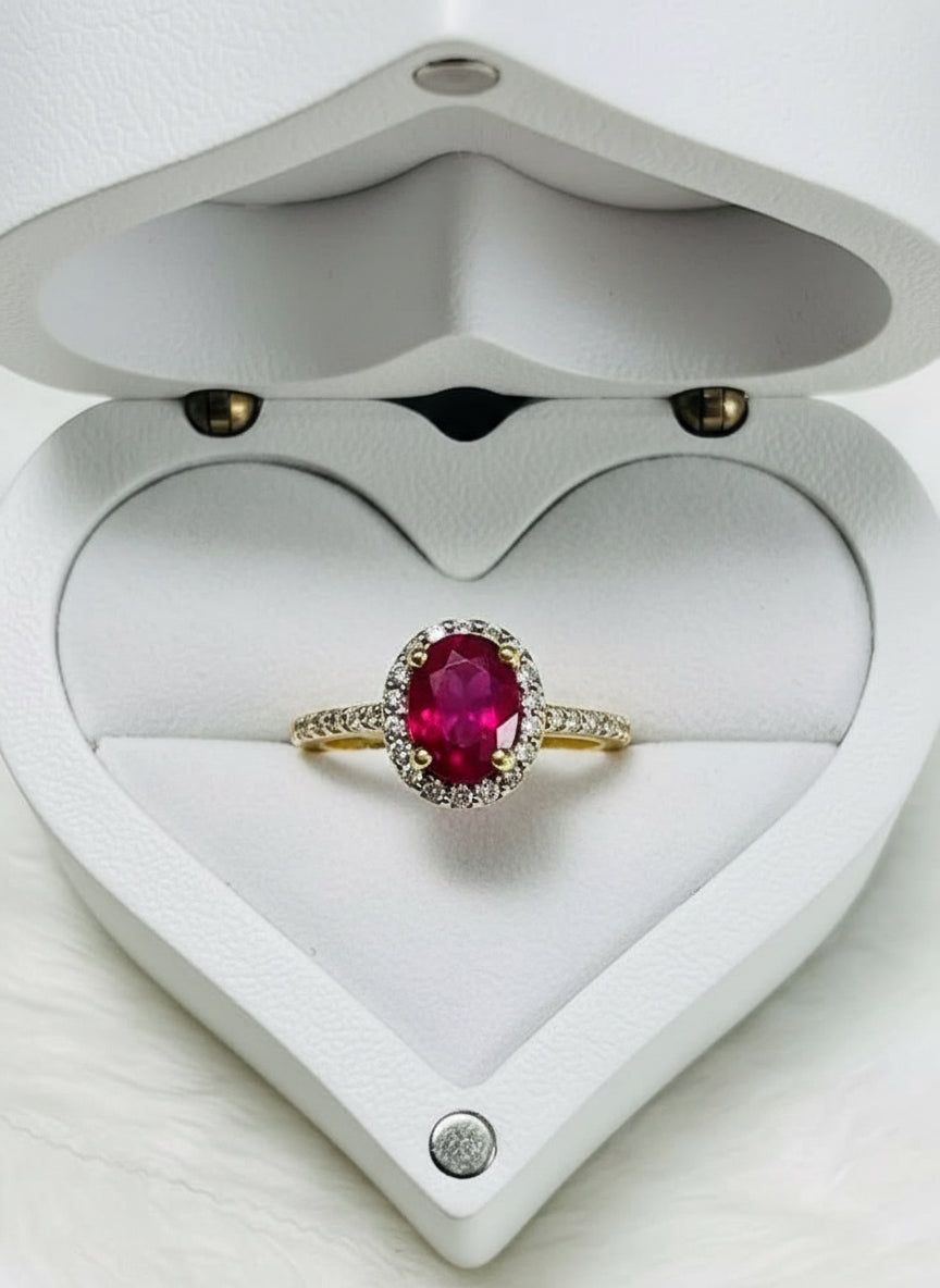 Natural ruby and natural diamond halo ring showcased in an open heart-shaped wooden box.