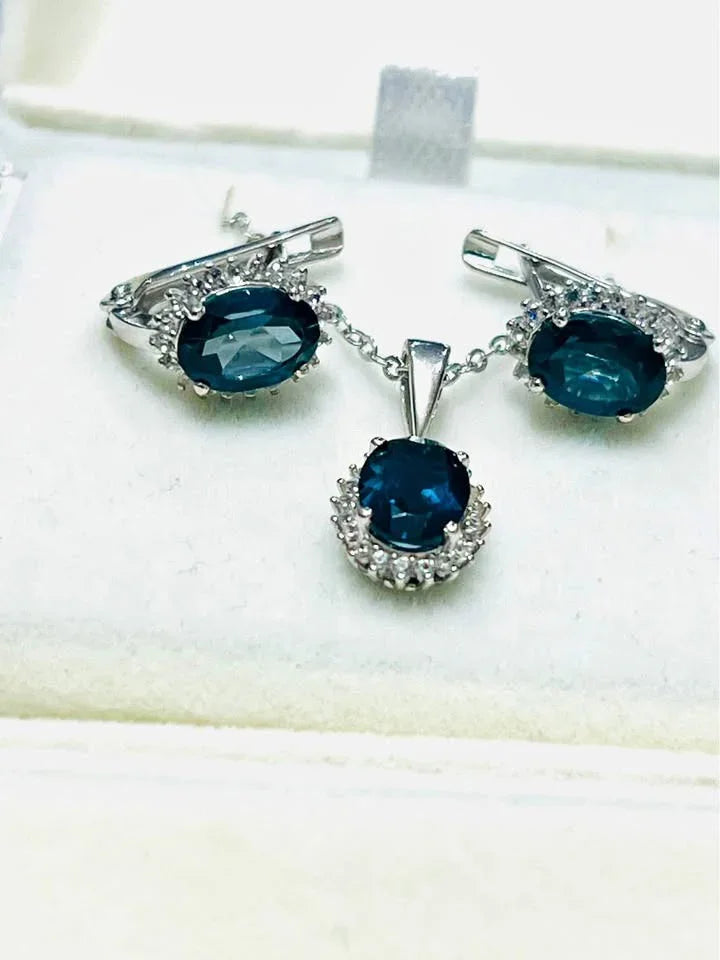 Oval natural London blue topaz necklace and matching earrings with sparkling accents.