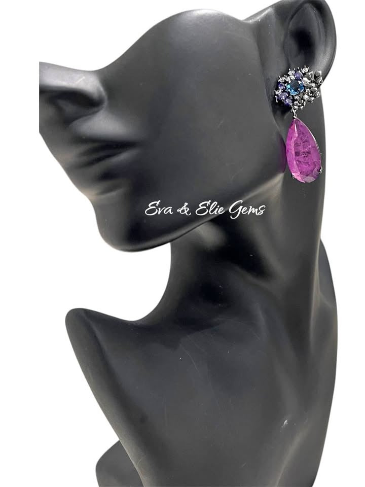 Model wearing a single Paraiba tourmaline sterling silver rhodium-plated earring, showcasing design.