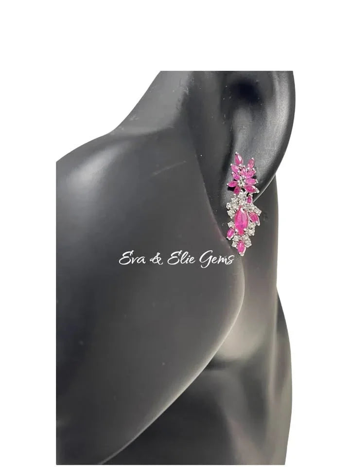 Pink ruby sterling silver earrings modeled on ear. Showcases elegant drop design & brilliant sparkle.
