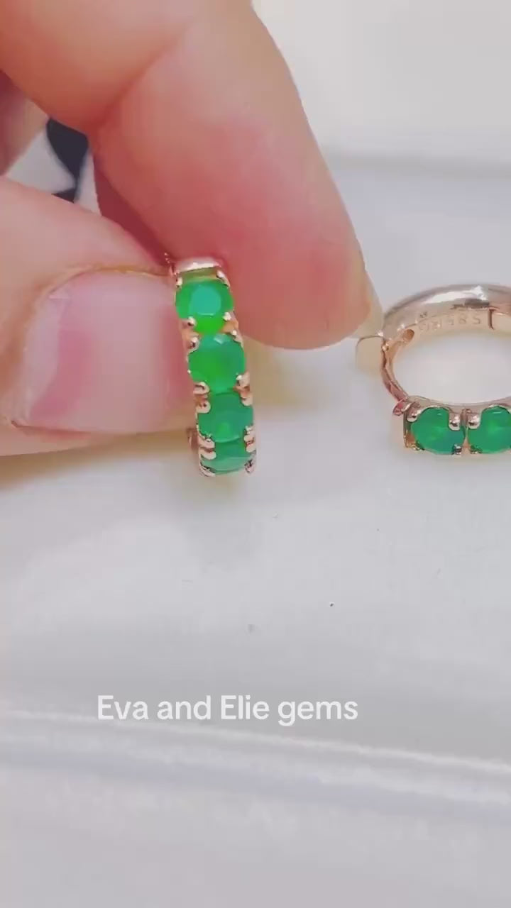 Video showing beautiful round-cut emerald hoop earrings, dainty and sparkling, ideal for adding elegance to any outfit.