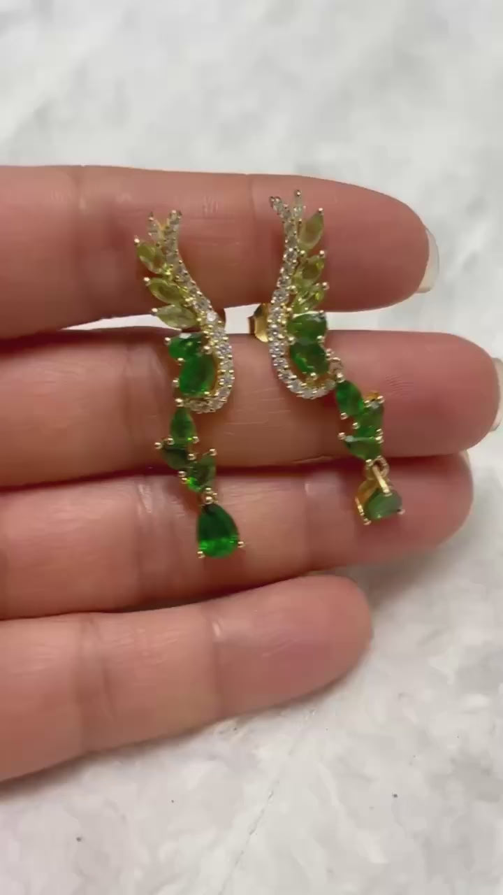 Real chrome diopside and peridot angel wing drop earrings, gold-toned.