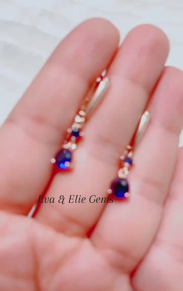 Sophisticated blue sapphire and accent stone drop earrings. Perfect for evening wear.
