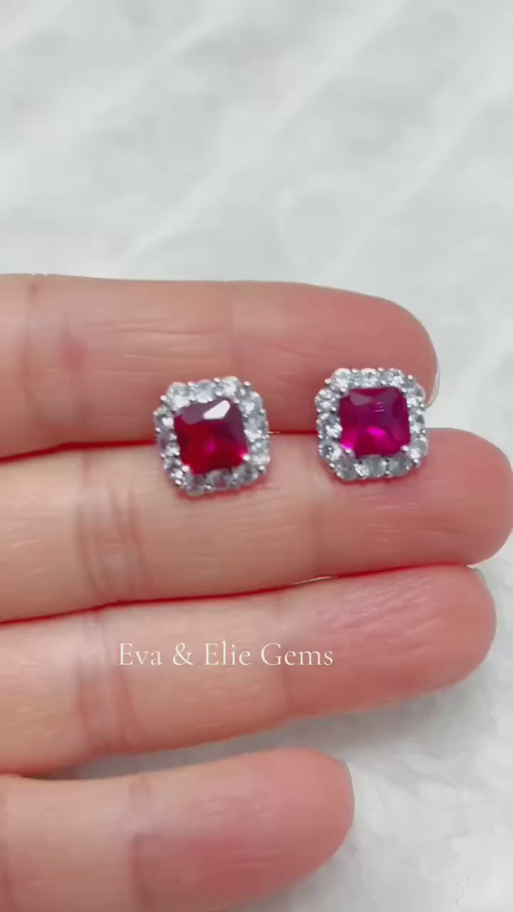 Vibrant red Ruby halo stud earrings. Beautiful sterling silver jewelry from Eva & Elie Gems.