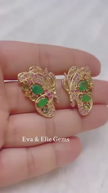 A stunning pair of earrings showcasing Colombian emeralds and pink sapphires in a delicate design.