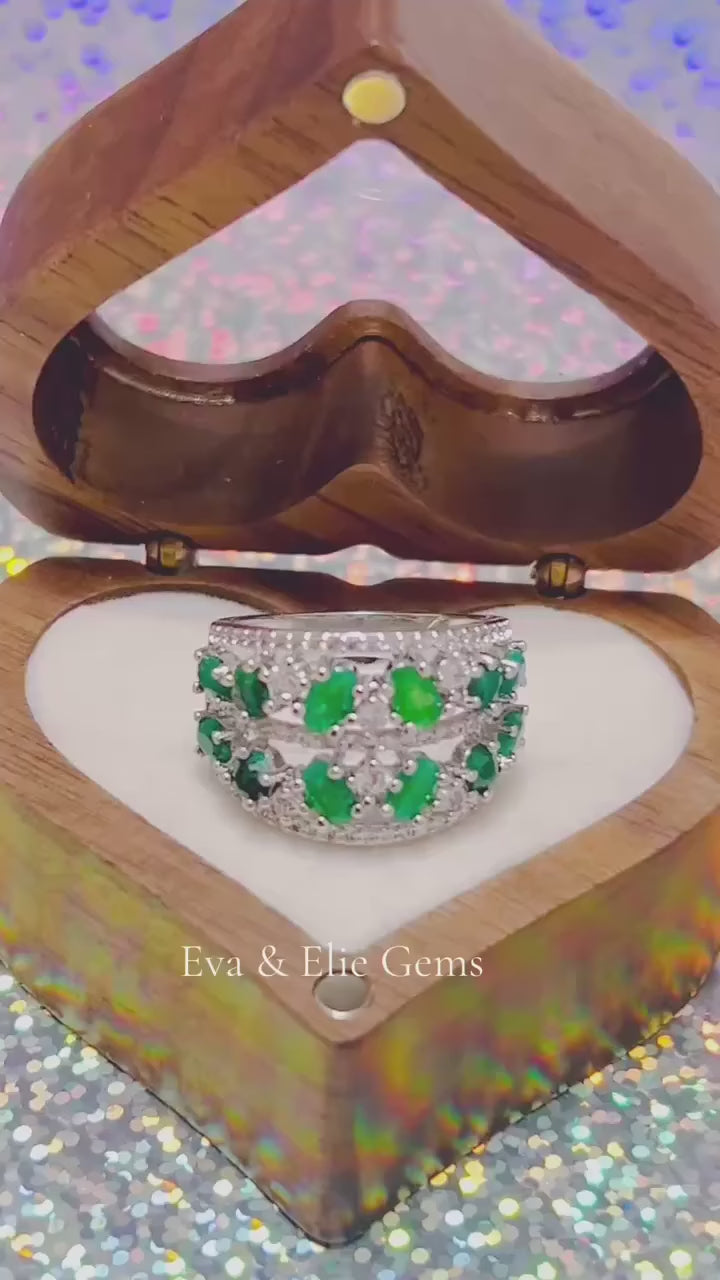 Natural emerald cluster ring in genuine sterling silver with brilliant clear stones.