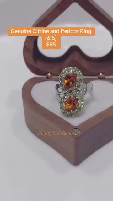  A beautiful ring showcasing a large citrine gemstone surrounded by sparkling peridots.