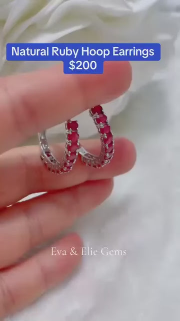 Sterling silver huggie hoop earrings with a row of natural rubies.