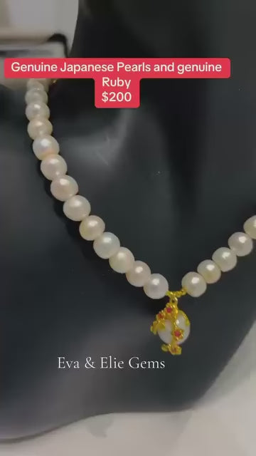 This necklace has a beautiful, natural pearl strand with a fancy pink ruby and gold flower pendant.