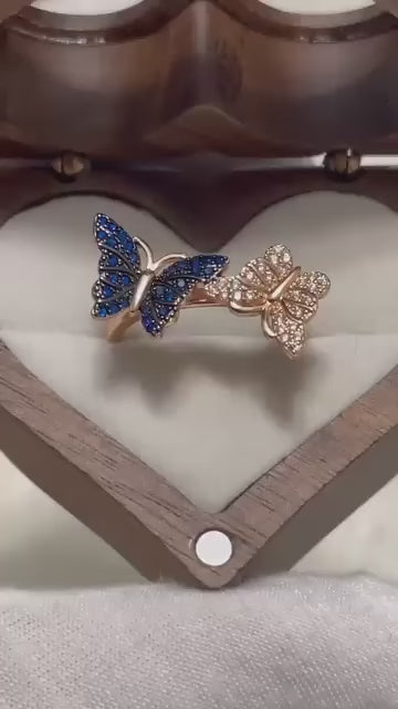 Unique ring with blue and clear gemstone butterflies. Elegant and eye-catching design.