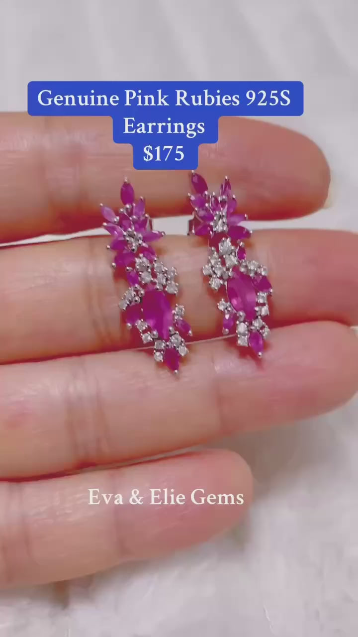 Elegant sterling silver earrings featuring a cluster of sparkling natural pink rubies.
