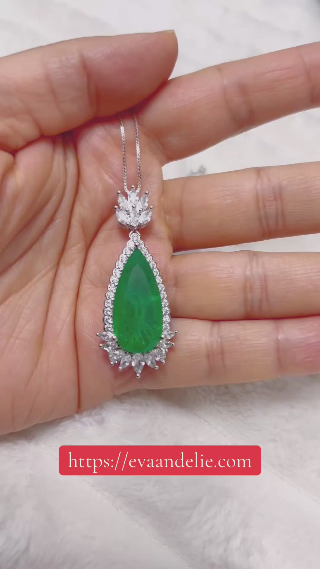 Beautiful green emerald and diamond necklace with a tear drop design, set in silver or white gold.