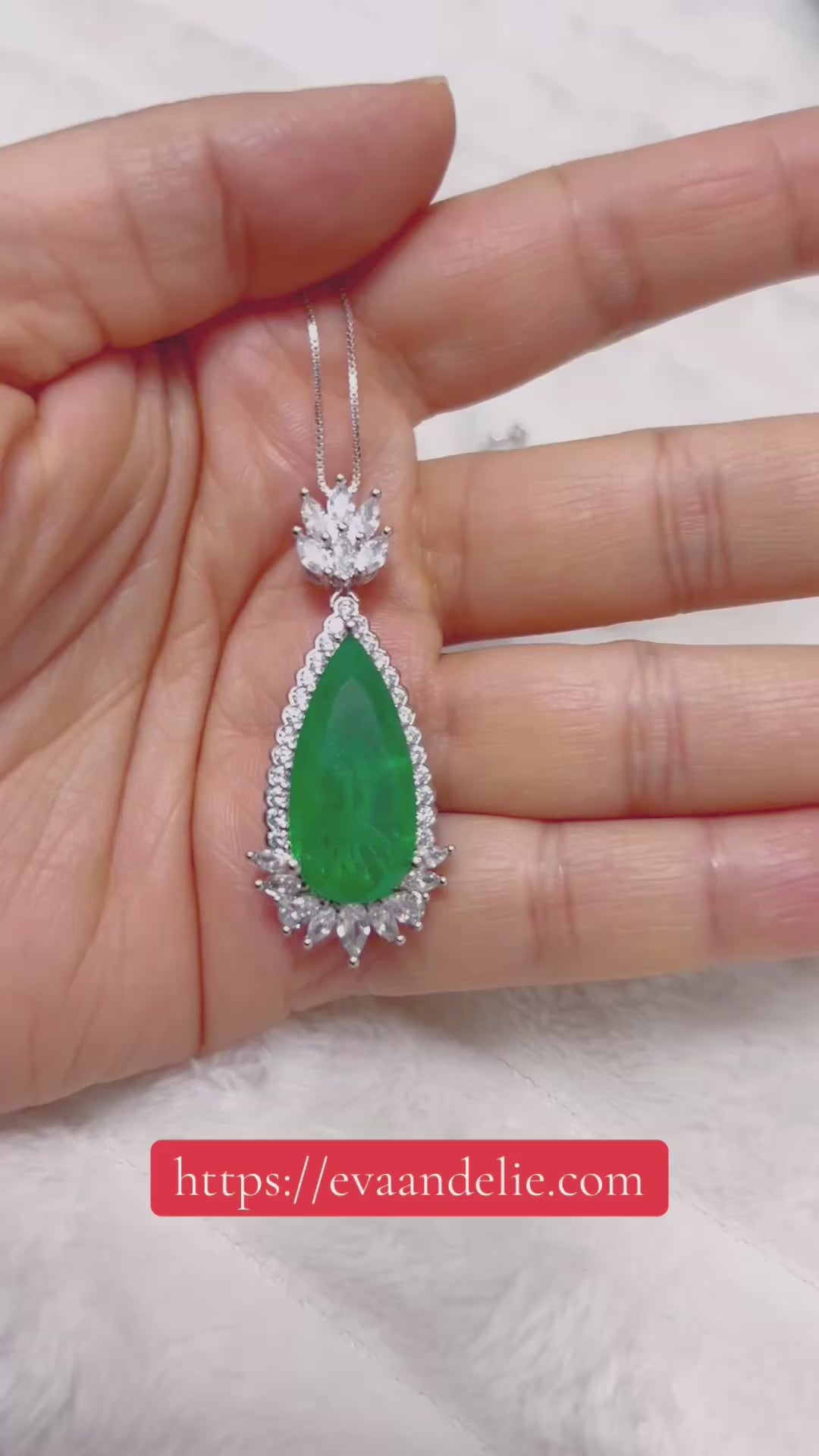 Beautiful green emerald and diamond necklace with a tear drop design, set in silver or white gold.