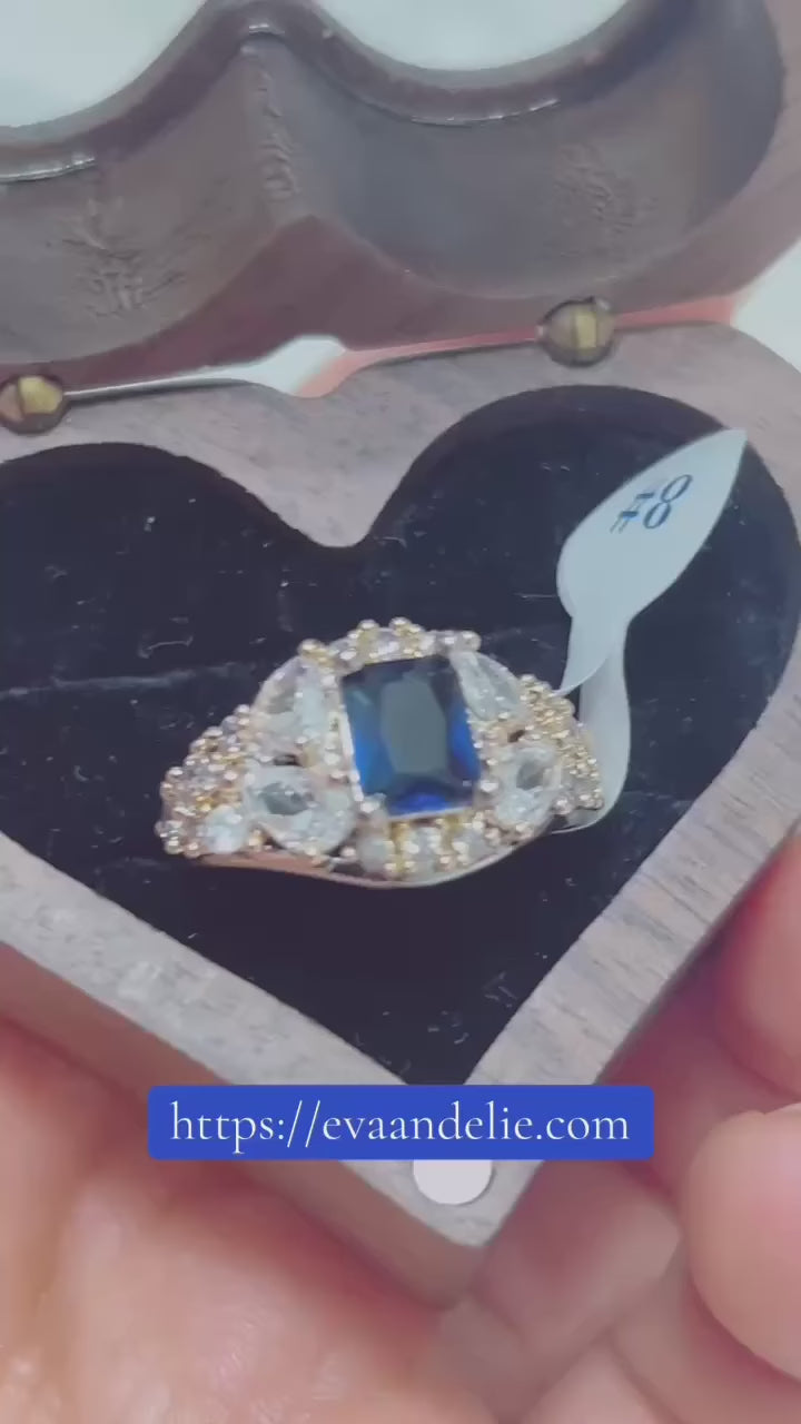  Stunning blue sapphire ring with marquise and round clear stones.