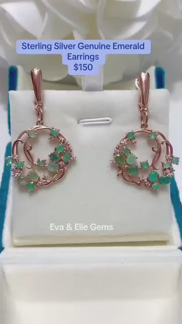 Beautiful natural emerald and sterling silver swirl hoop earrings. Unique elegant design.
