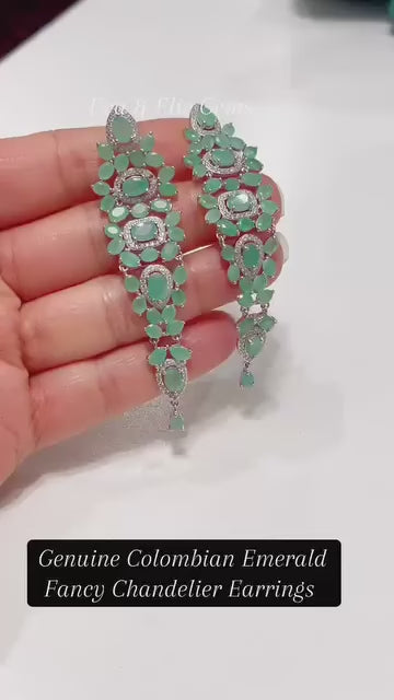 A pair of fancy chandelier earrings featuring genuine Colombian emeralds.