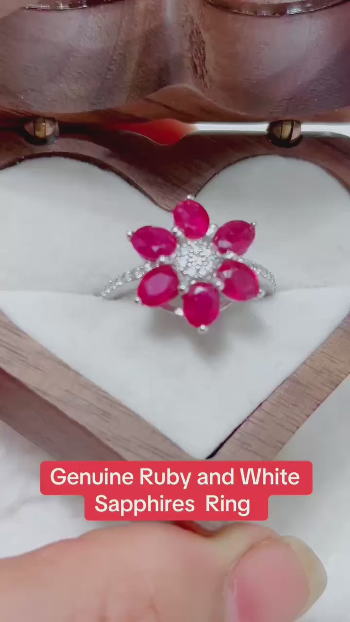 Genuine ruby and white sapphire flower ring in a sparkling silver-toned setting.