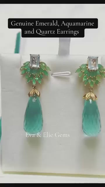 A showstopping pair of dangle earrings featuring a cascade of natural emerald, aquamarine, and quartz stones.
