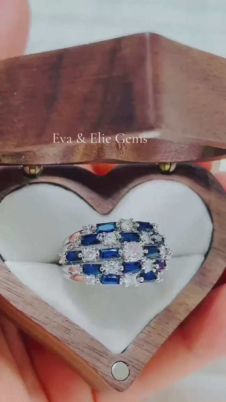 Luxurious blue sapphire and diamond statement ring, showcasing a beautiful geometric pattern in a wooden box.