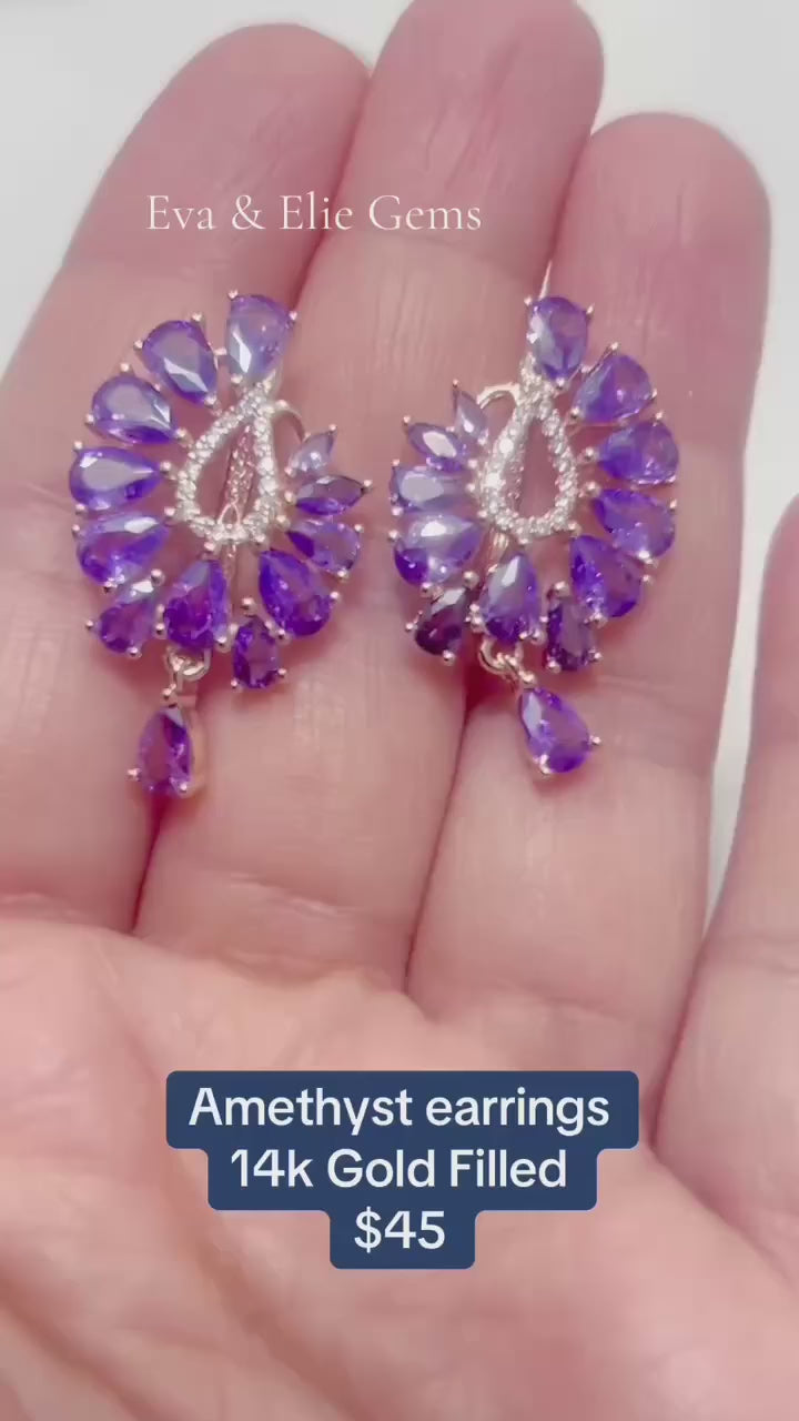  A pair of elegant drop earrings featuring beautiful, genuine amethyst stones.