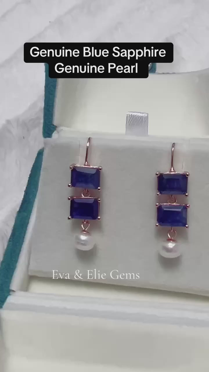 A beautiful pair of dangle earrings with genuine blue sapphires and freshwater pearls.