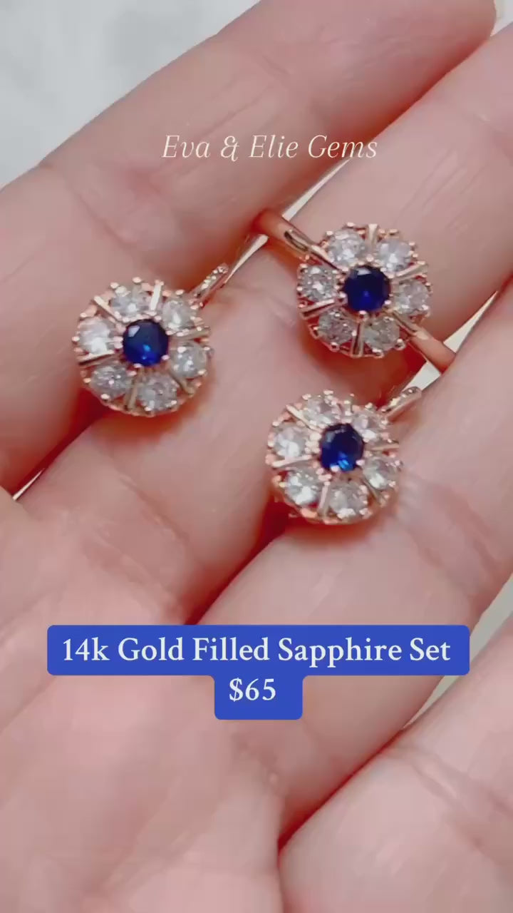 This jewelry set showcases a beautiful flower cluster design with genuine blue sapphires.