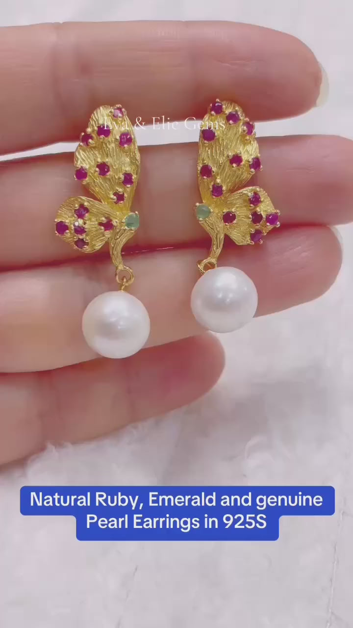 Handmade artisan earrings with a butterfly design, featuring natural ruby, emerald, and pearl gemstones.
