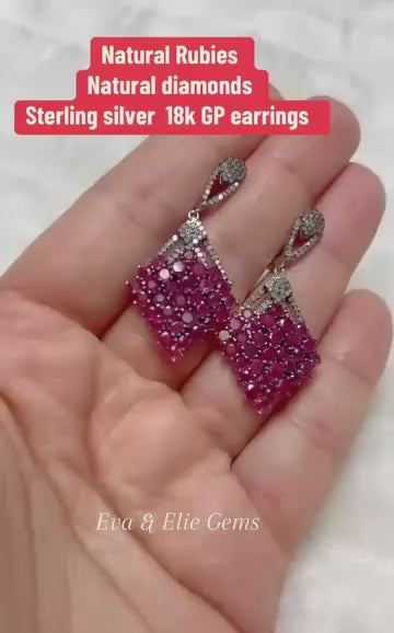 Striking dangle earrings featuring a beautiful arrangement of rubies and accent diamonds.