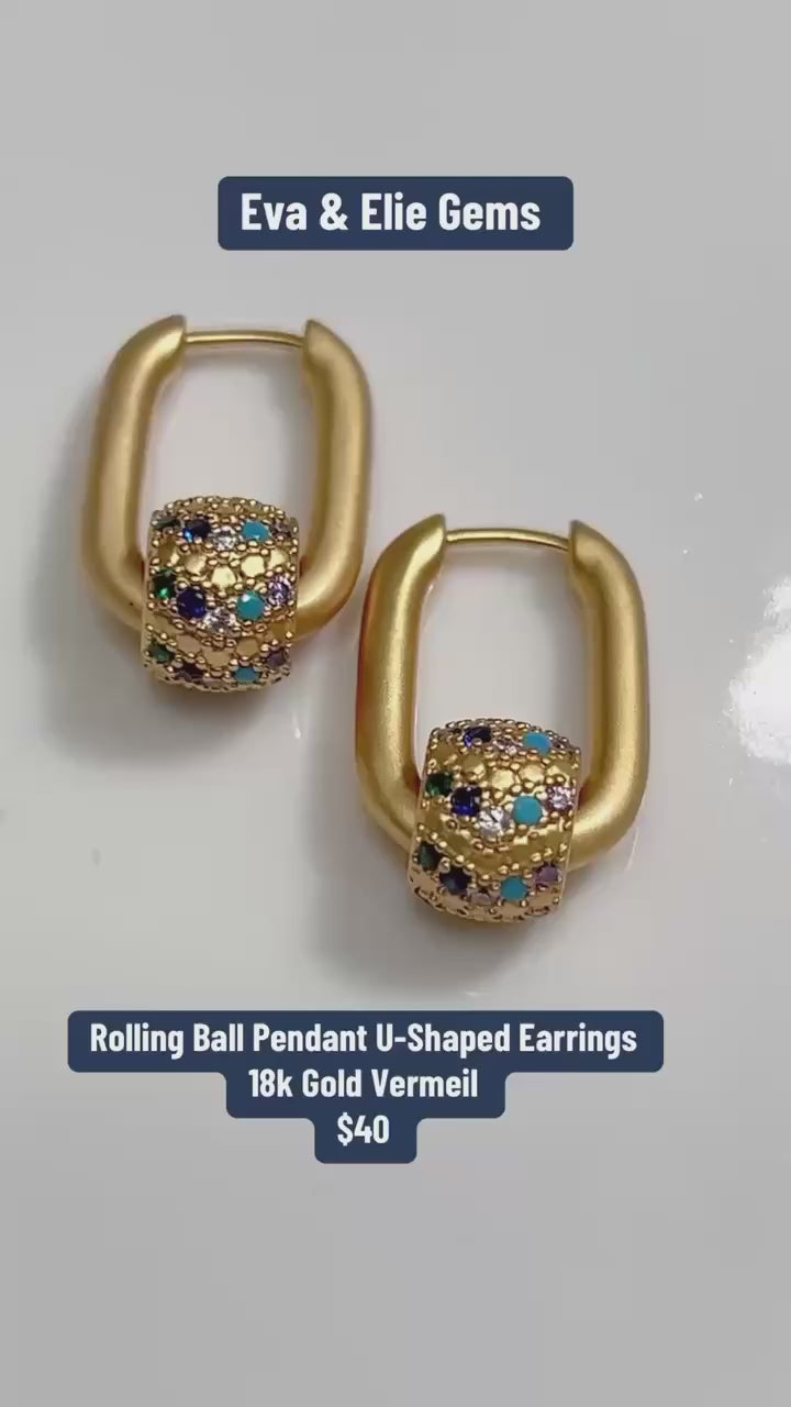 These unique 18k gold vermeil dangle earrings feature a playful rolling ball design.