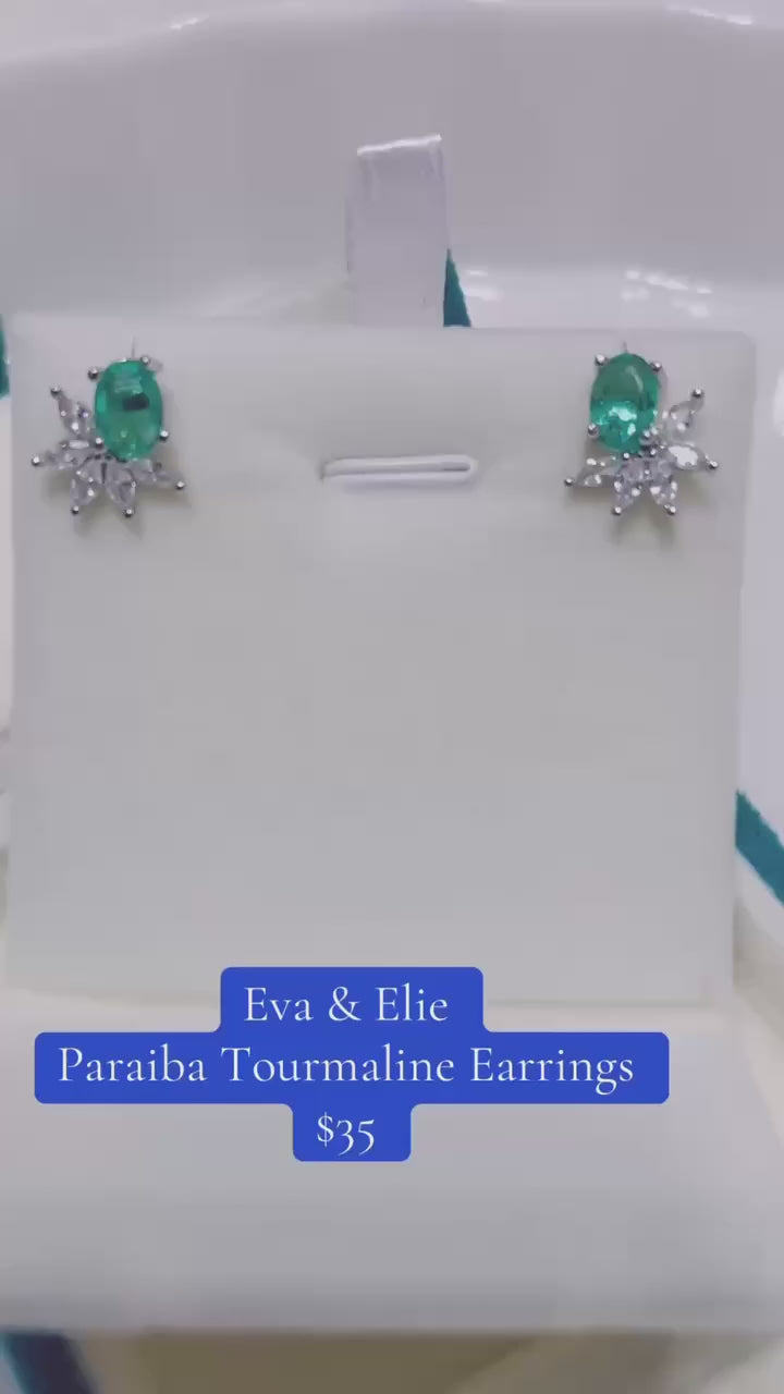 Elegant flower-shaped sterling silver earrings with a beautiful green Paraiba tourmaline gemstone.