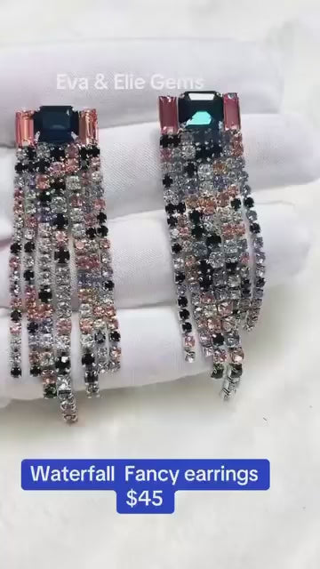 Stunning earrings with a vibrant mix of blue, green, pink, and black stones in a cascading design.