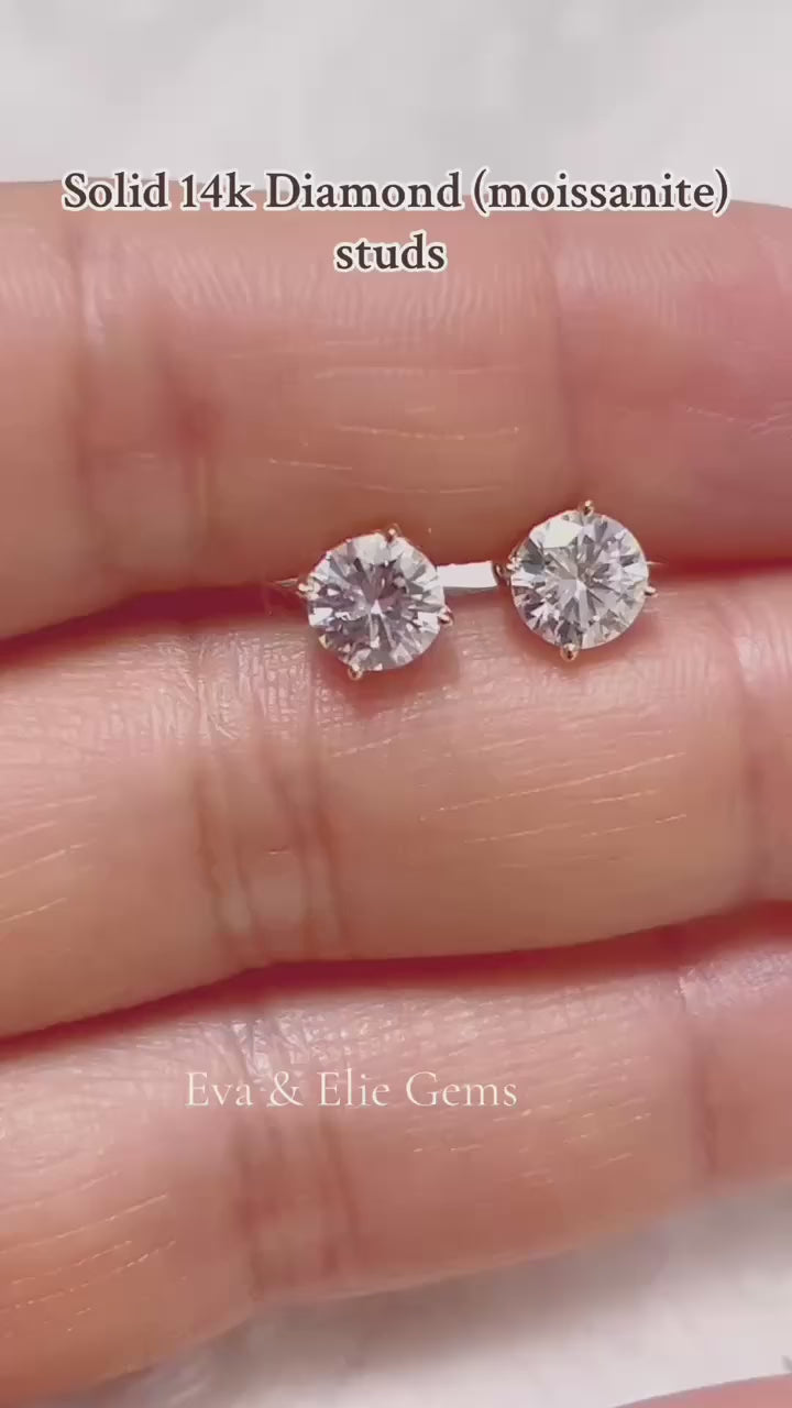 Dazzling round moissanite studs in 14k gold, perfect for everyday elegance.