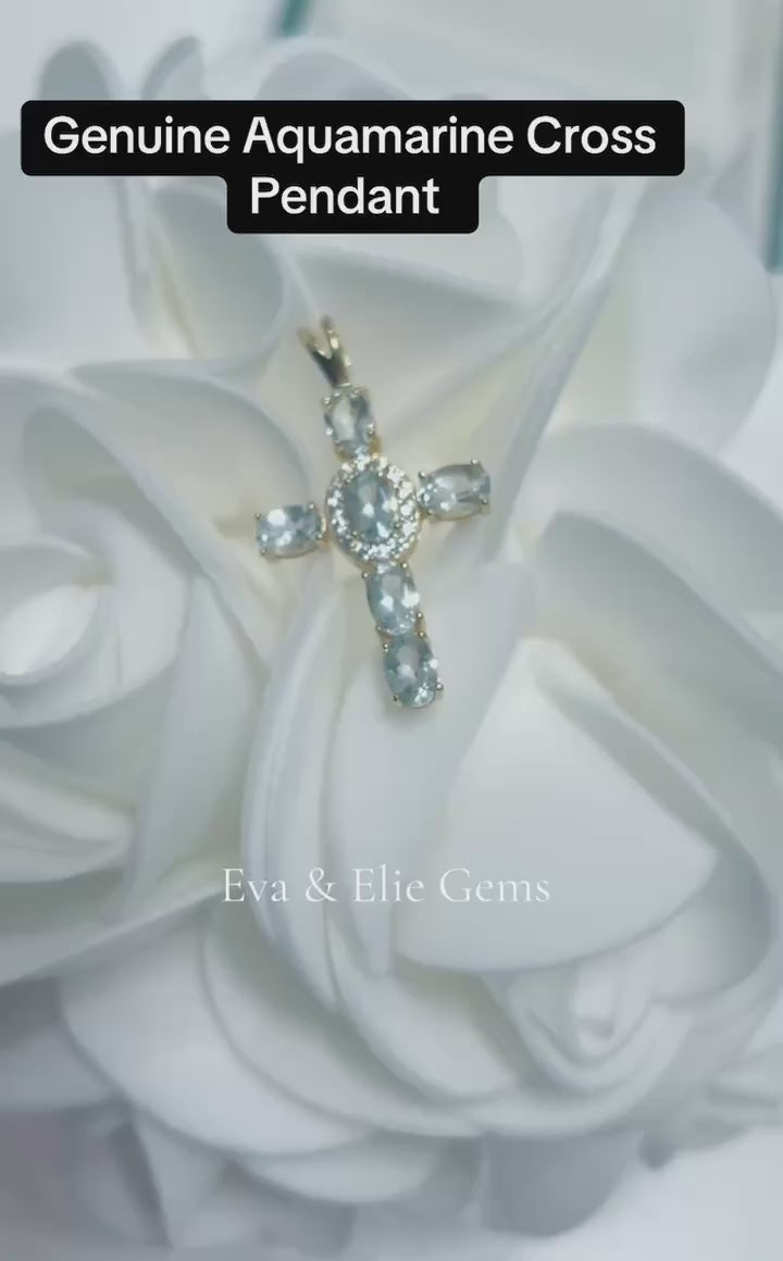 A stunning cross pendant featuring natural blue aquamarine gemstones, perfect for a meaningful gift.