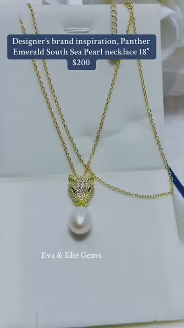 Exquisite panther pendant with emerald eyes and a genuine South Sea pearl, 18" chain.