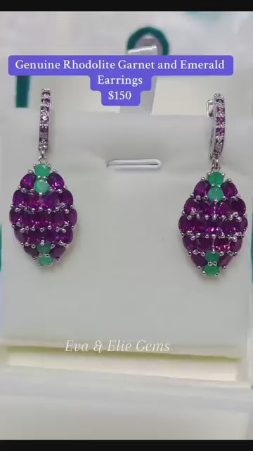 A pair of striking earrings with a vibrant combination of natural emerald and rhodolite garnet gemstones.