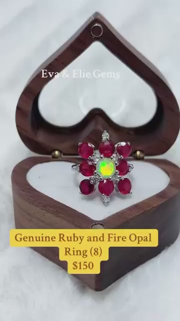 An eye-catching sterling silver ring with a flower design, featuring a central fire opal and ruby gemstones.