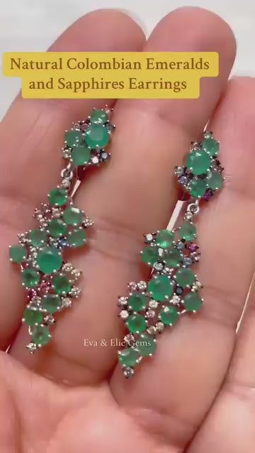 Genuine sterling silver earrings featuring natural emeralds and sapphires in a drop design.