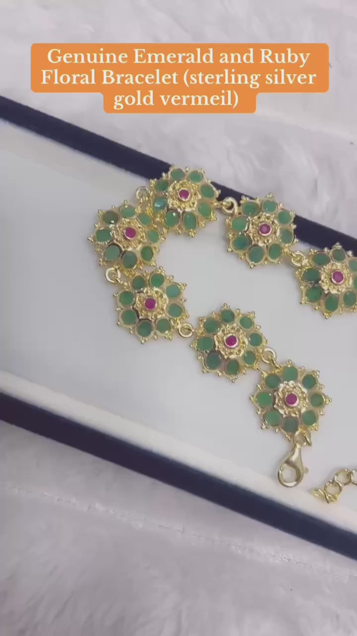  Stunning bracelet with natural Colombian emerald and ruby floral clusters.