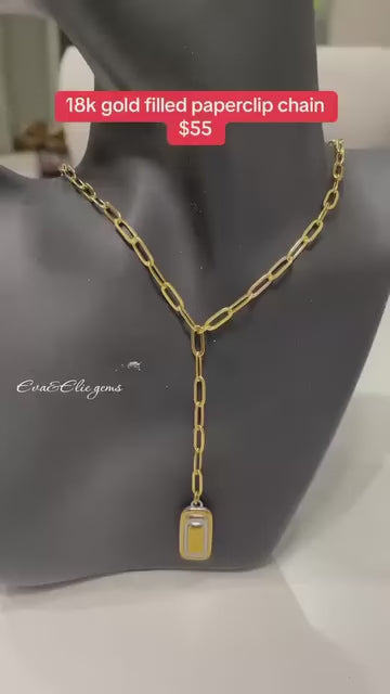 Trendy paperclip chain lariat necklace with a sleek pendant, perfect for contemporary style.