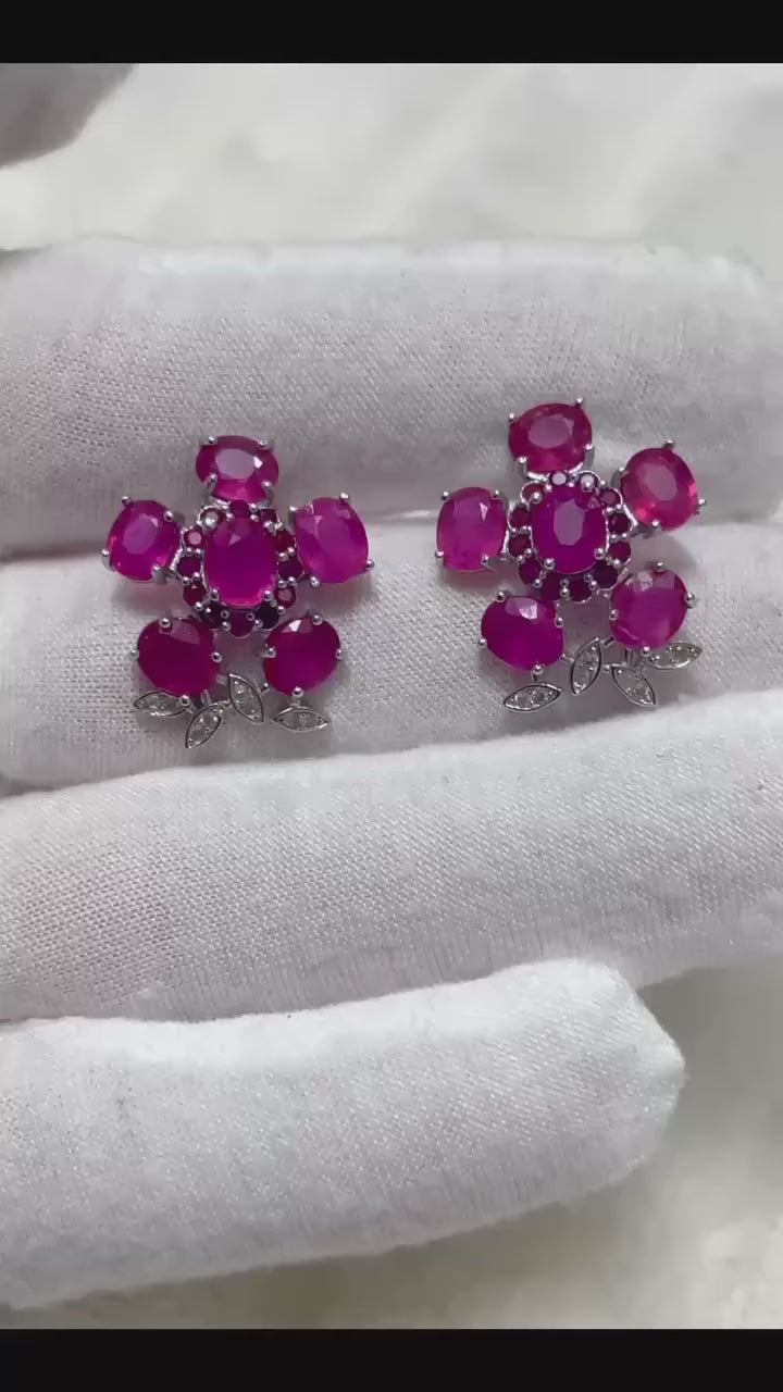 These lovely earrings feature genuine pink rubies set in sterling silver for a touch of elegance.