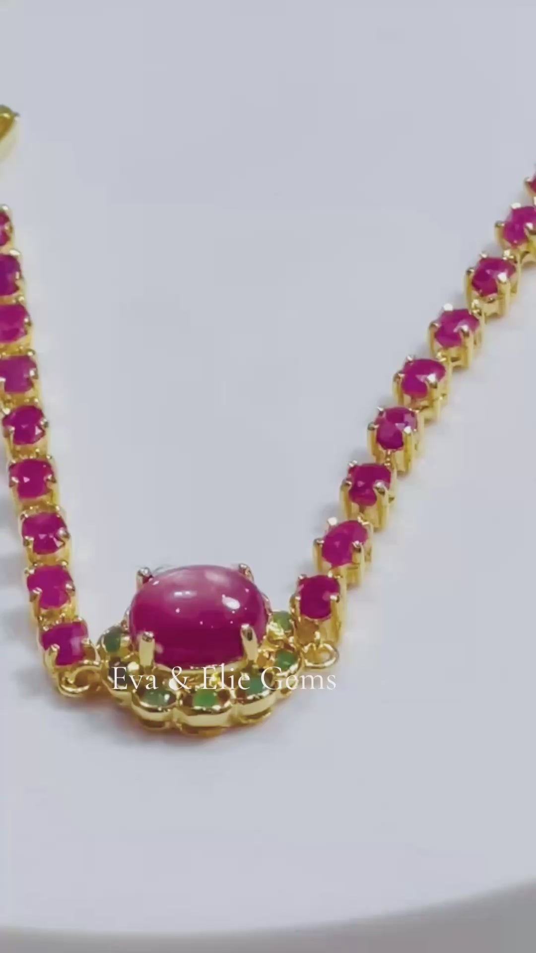 Stunning gold bracelet adorned with genuine Burmese rubies and emeralds, a luxurious and colorful piece.