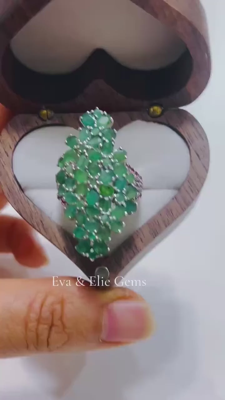 Exquisite multi-gemstone statement ring with Emeralds and Rhodolite Garnets. Luxurious.