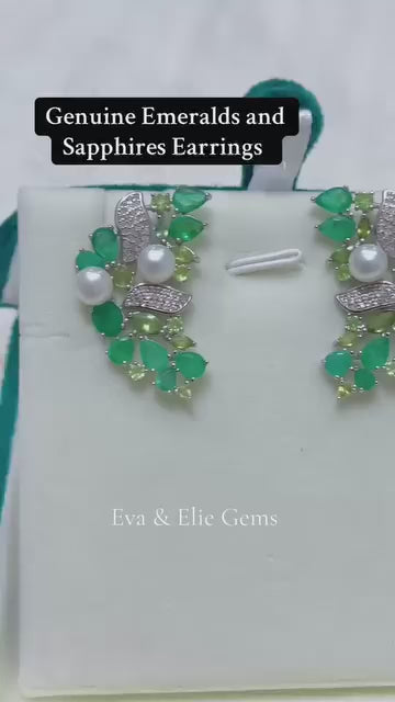 These unique earrings are made with Colombian emeralds and genuine pearls in an elegant cluster design.