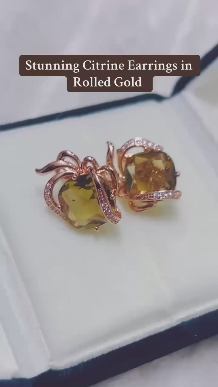  Stunning earrings with a faceted citrine gemstone set in rolled gold.