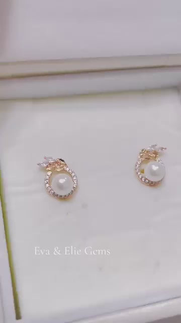 Timeless pearl earrings with delicate clear stone accents, perfect for sophisticated style.