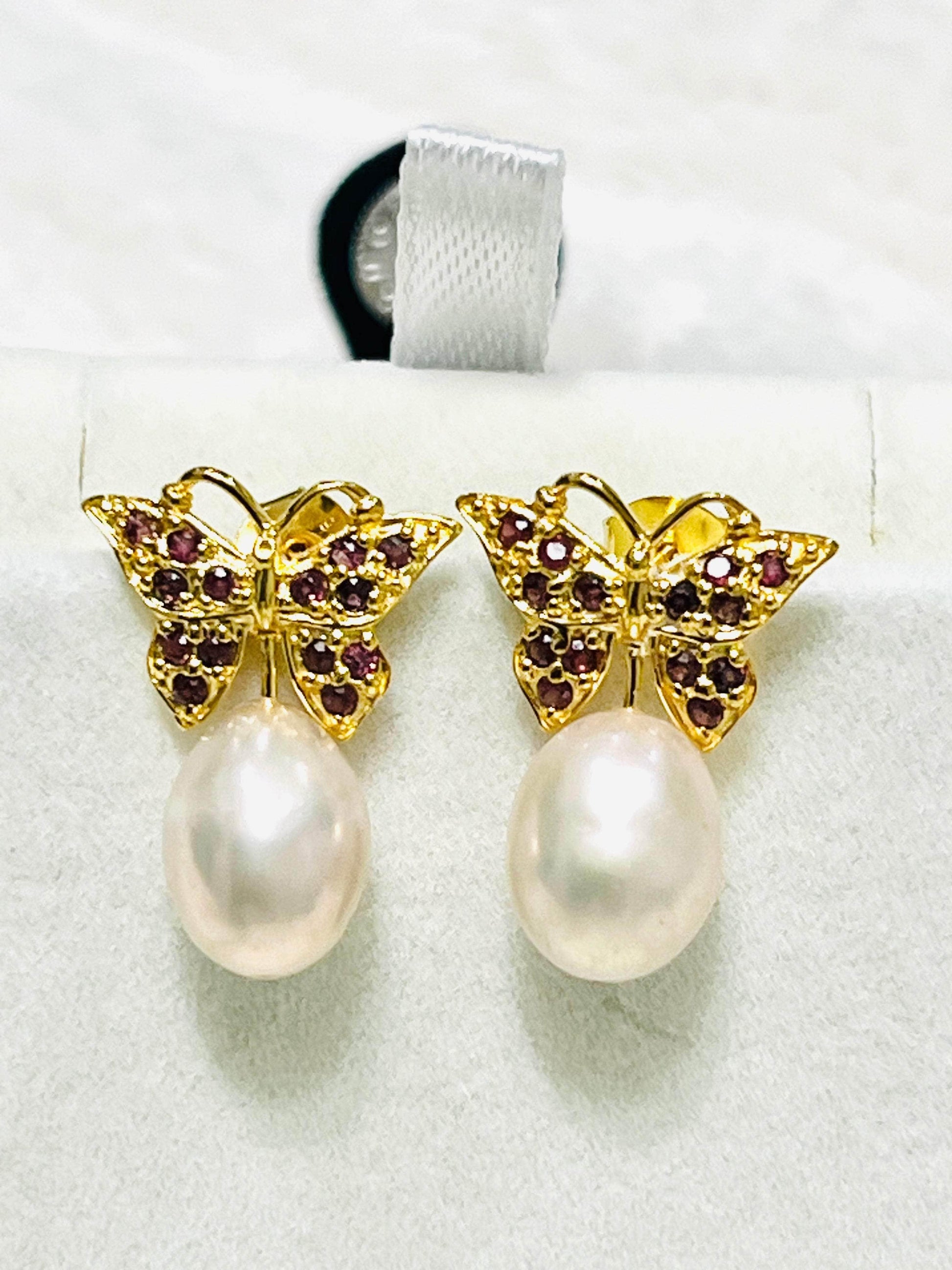Stunning rhodolite garnet butterfly earrings with genuine pink pearl drops and intricate gold detailing.