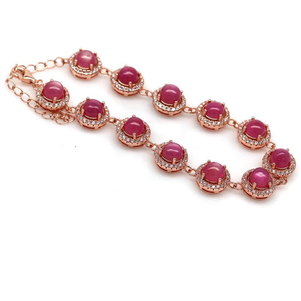 Elegant rose gold bracelet showcasing a full view of natural ruby cabochons surrounded by cubic zirconia.