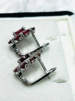 Back view of the ruby and diamond halo earrings, highlighting the solid sterling silver craftsmanship and secure earring posts
