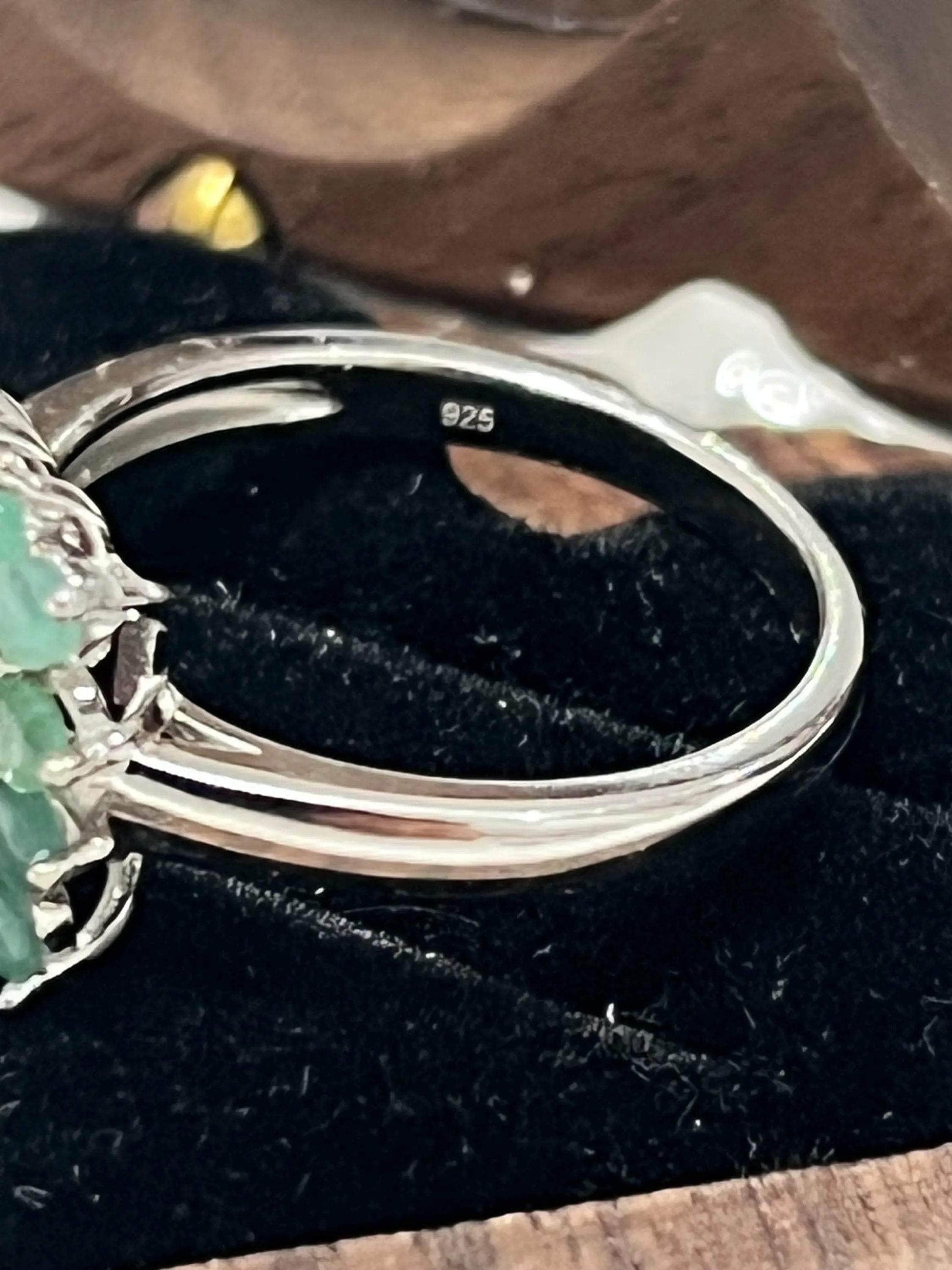 Extreme close-up of the .925 sterling silver hallmark on a handmade ruby and emerald gemstone ring.