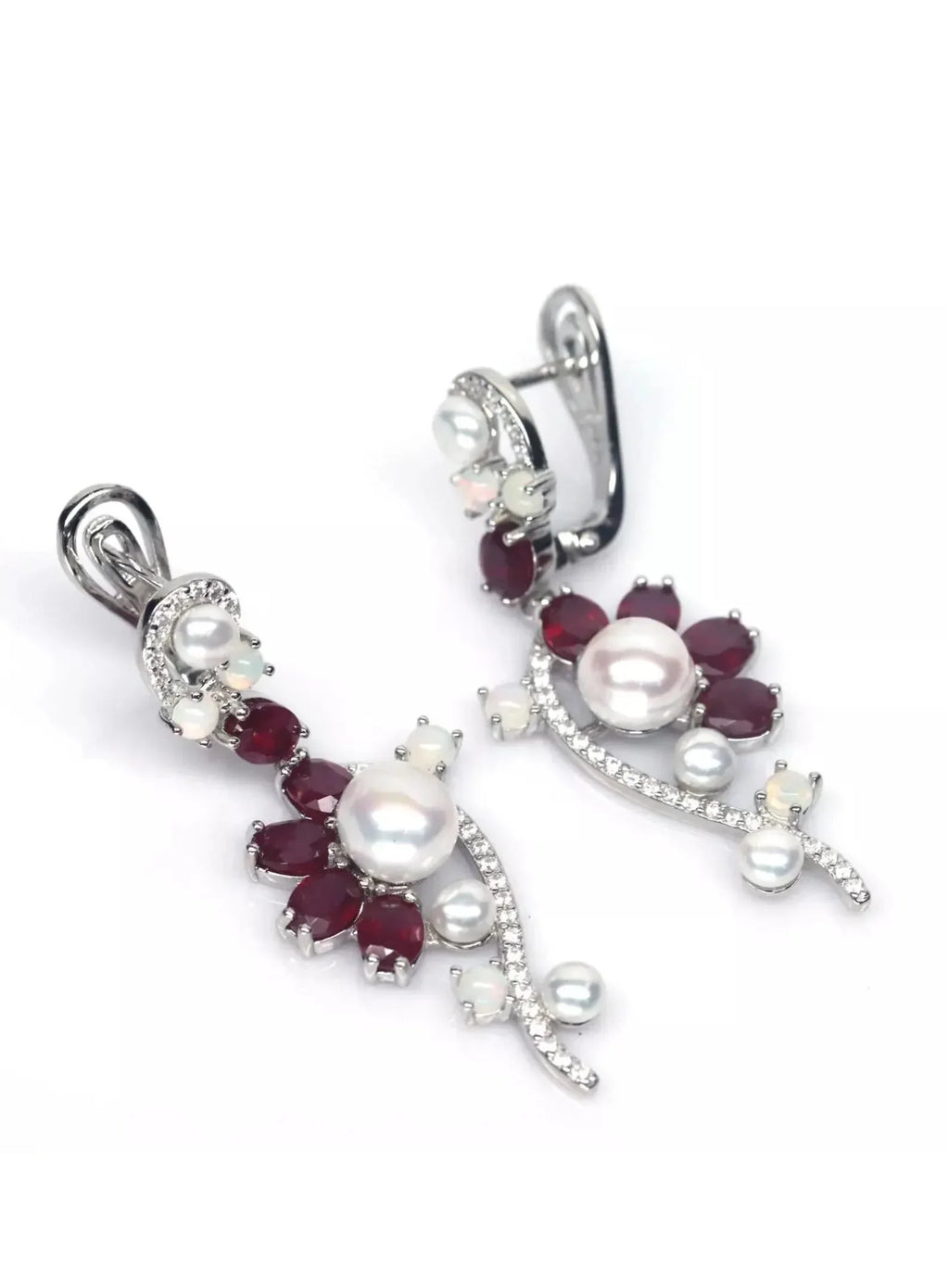 Beautiful long dangle earrings with rubies, opals, and pearls, showcasing their design on a white background.